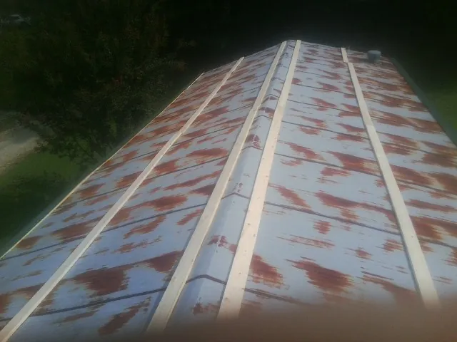 Rusted metal roof panels with new wood purlins before replacement — Storm Damage Roof Repair in Placentia by Roofing Brothers