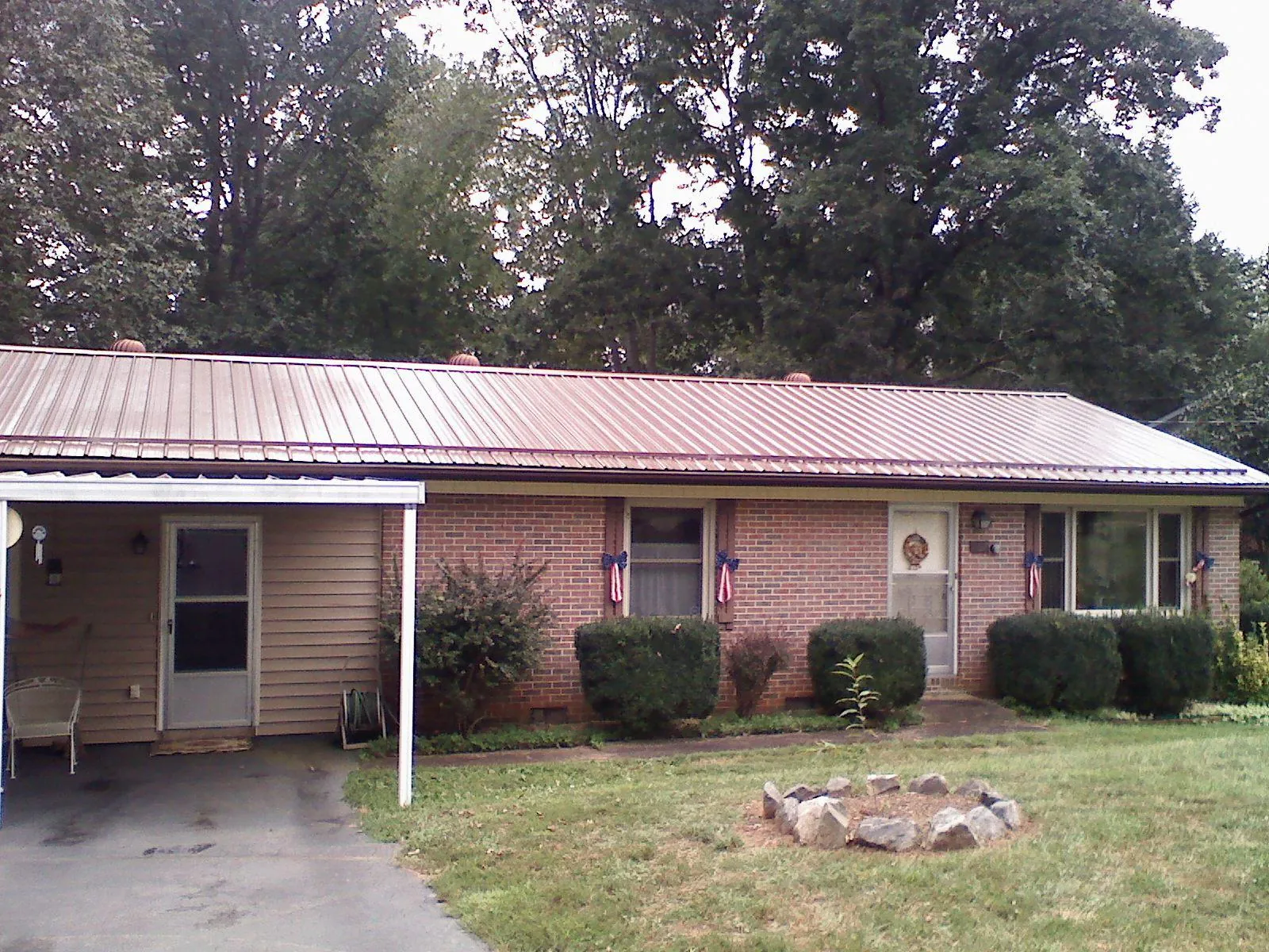 Bronze metal roof and carport on a brick ranch home — Roof Repair work by our crew in Placentia